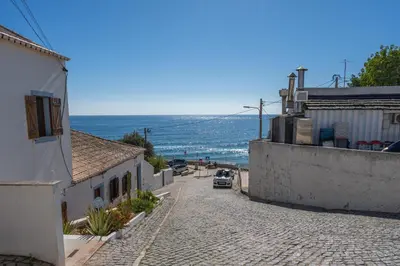 a cobble stone street with a view of the ocean at Casa da Praia 2 in Budens