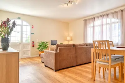 a living room with a couch and a table at Nidia’s Place, a Home in Madeira in Machico