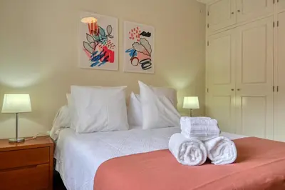 a bedroom with a bed with two towels on it at Nidia’s Place, a Home in Madeira in Machico