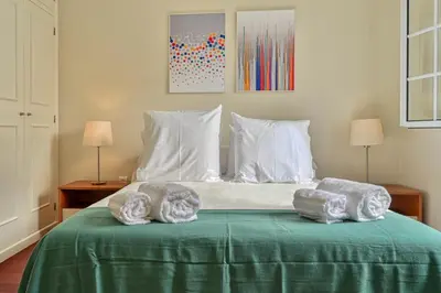 a bedroom with a bed with two towels on it at Nidia’s Place, a Home in Madeira in Machico