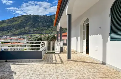 a balcony of a house with a mountain in the background at Nidia’s Place, a Home in Madeira in Machico