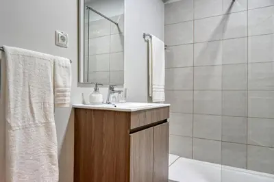 a bathroom with a sink and a shower at Nidia’s Place, a Home in Madeira in Machico