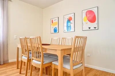 a dining room with a wooden table and chairs at Nidia’s Place, a Home in Madeira in Machico