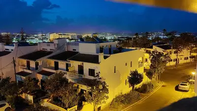 a large white building with a city in the background at 202 Lagood in Lagos