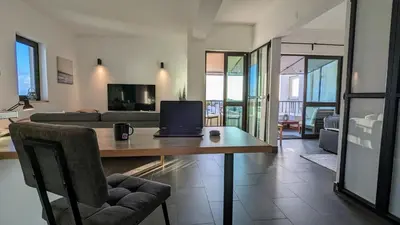 a living room with a table with a laptop on it at 202 Lagood in Lagos