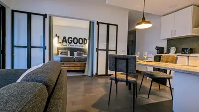 a kitchen and living room with a table and chairs at 202 Lagood in Lagos