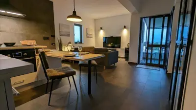 a kitchen and living room with a table and a couch at 202 Lagood in Lagos