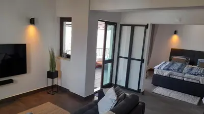 a living room with a couch and a tv at 202 Lagood in Lagos