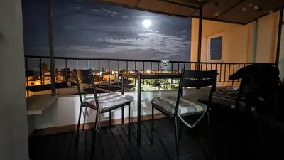 a balcony with a table and chairs on a balcony at 202 Lagood in Lagos