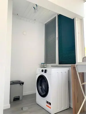 a washer and dryer in a room with a window at Madeira, 3 bedroom apartment with ocean views in Funchal in Funchal