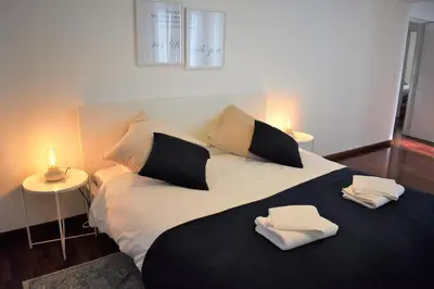 a bedroom with a large bed with two towels on it at Madeira, 3 bedroom apartment with ocean views in Funchal in Funchal