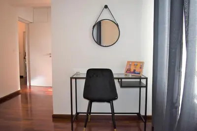 a desk with a black chair and a mirror at Madeira, 3 bedroom apartment with ocean views in Funchal in Funchal