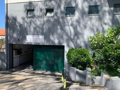 a building with a green door on the side of it at Madeira, 3 bedroom apartment with ocean views in Funchal in Funchal