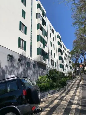 a car parked in front of a large building at Madeira, 3 bedroom apartment with ocean views in Funchal in Funchal