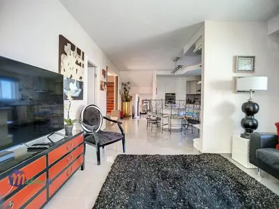 a living room with a large television and a couch at PEARLS BEACH VILLA in Porto Moniz