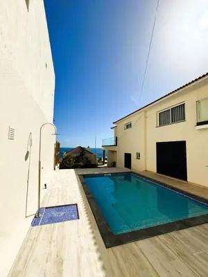 a swimming pool in the backyard of a house at PEARLS BEACH VILLA in Porto Moniz