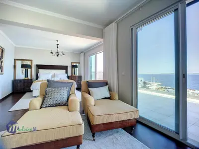 a bedroom with a bed and a couch and a window at PEARLS BEACH VILLA in Porto Moniz