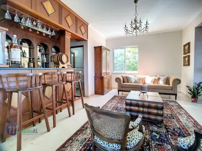 a living room with a bar and a couch at PEARLS BEACH VILLA in Porto Moniz
