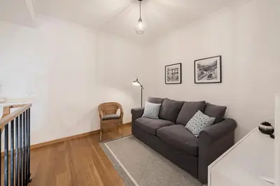 a living room with a couch and a chair at Casa Caetano by An Island Apart in Funchal