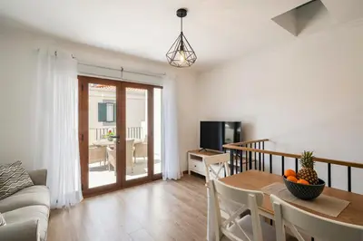 a living room with a table and a couch at Casa Caetano by An Island Apart in Funchal