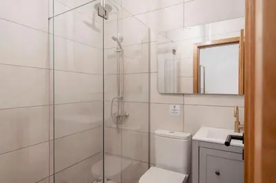 a bathroom with a shower with a toilet and a sink at Casa Caetano by An Island Apart in Funchal