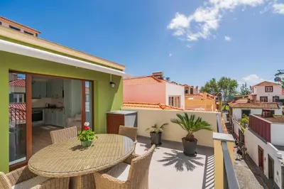 a patio with a table and chairs on a balcony at Casa Caetano by An Island Apart in Funchal