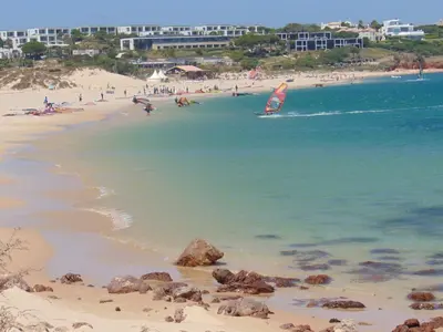 a beach with a group of people in the water at Cool Villas T2 in Sagres