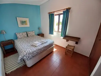 a bedroom with a bed and a window at Cool Villas T2 in Sagres