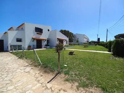 a house with a fence in front of a yard at Cool Villas T2 in Sagres