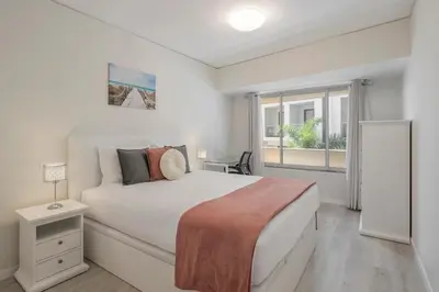 a bedroom with a large white bed and a window at Varandas do Lido I by An Island Apart in Funchal