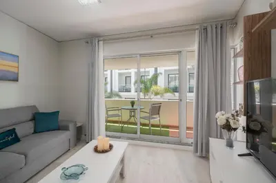 a living room with a couch and a large window at Varandas do Lido I by An Island Apart in Funchal