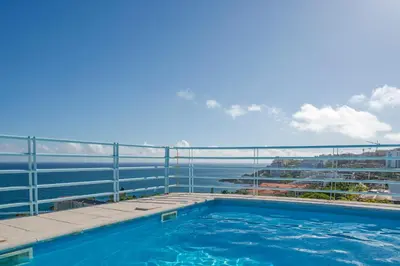 a swimming pool on the balcony of a building at Varandas do Lido I by An Island Apart in Funchal
