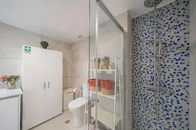a bathroom with a toilet and a glass shower at Varandas do Lido I by An Island Apart in Funchal