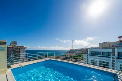 a swimming pool on the balcony of a building at Varandas do Lido I by An Island Apart in Funchal