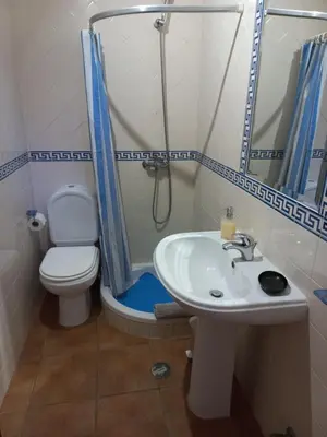 a bathroom with a toilet and a sink and a shower at Cool Villas T4 in Sagres