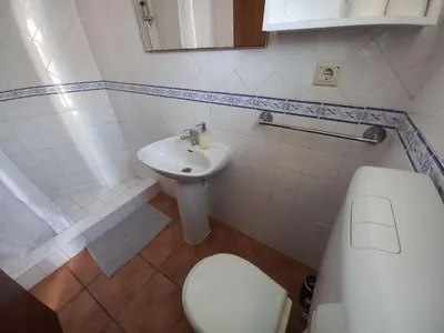 a bathroom with a white toilet and a sink at Cool Villas T4 in Sagres