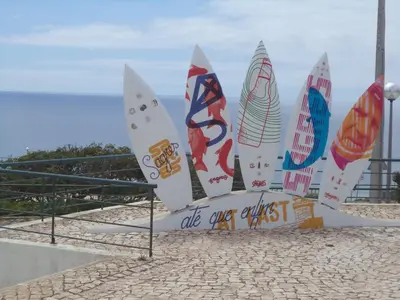 a group of surfboards on a sign on the beach at Cool Villas T4 in Sagres