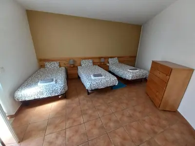 a room with two beds and a dresser at Cool Villas T4 in Sagres