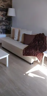 a living room with a couch and a table at Casa do Avô in Ponta do Sol