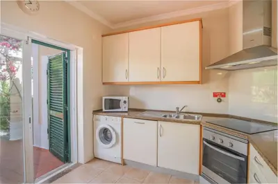 a kitchen with a sink and a washing machine at Villa Acacias 18, Brisa do Mar in Luz
