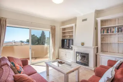 a living room with a couch and a fireplace at Villa Acacias 18, Brisa do Mar in Luz