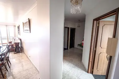 a hallway with a dining room and a room with a chandelier at Sea and sunset view apartment in Funchal in Funchal