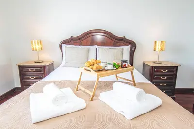 a bedroom with a bed with a table with towels on it at Sea and sunset view apartment in Funchal in Funchal
