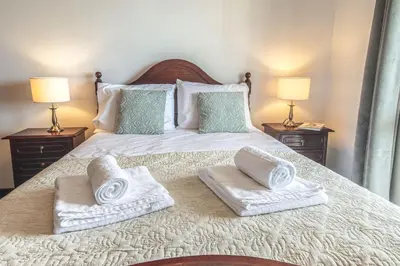 a bedroom with a bed with towels on it at Sea and sunset view apartment in Funchal in Funchal