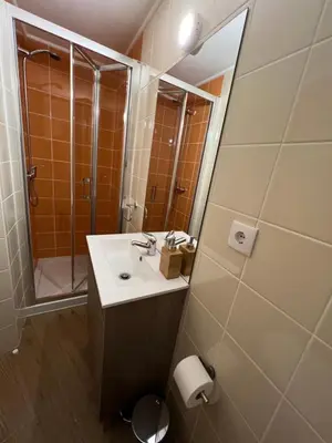a bathroom with a sink and a shower with a mirror at Casa Arenga in Almádena
