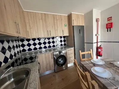 a kitchen with a sink and a washing machine at Casa Arenga in Almádena