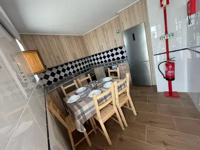 a dining room with a table and chairs and a fire hydrant at Casa Arenga in Almádena