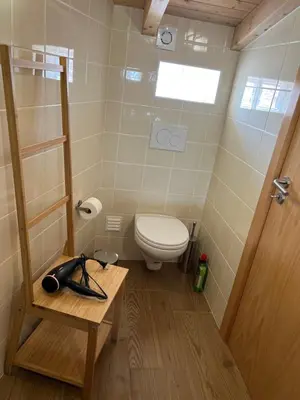 a small bathroom with a toilet and a wooden table at Casa Arenga in Almádena