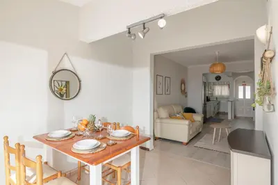 a kitchen and living room with a table and chairs at Terrace Vila II by An Island Apart in Santa Cruz