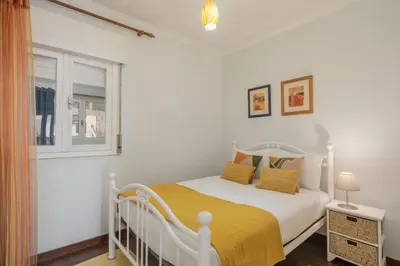 a white bedroom with a white bed and a window at Terrace Vila II by An Island Apart in Santa Cruz